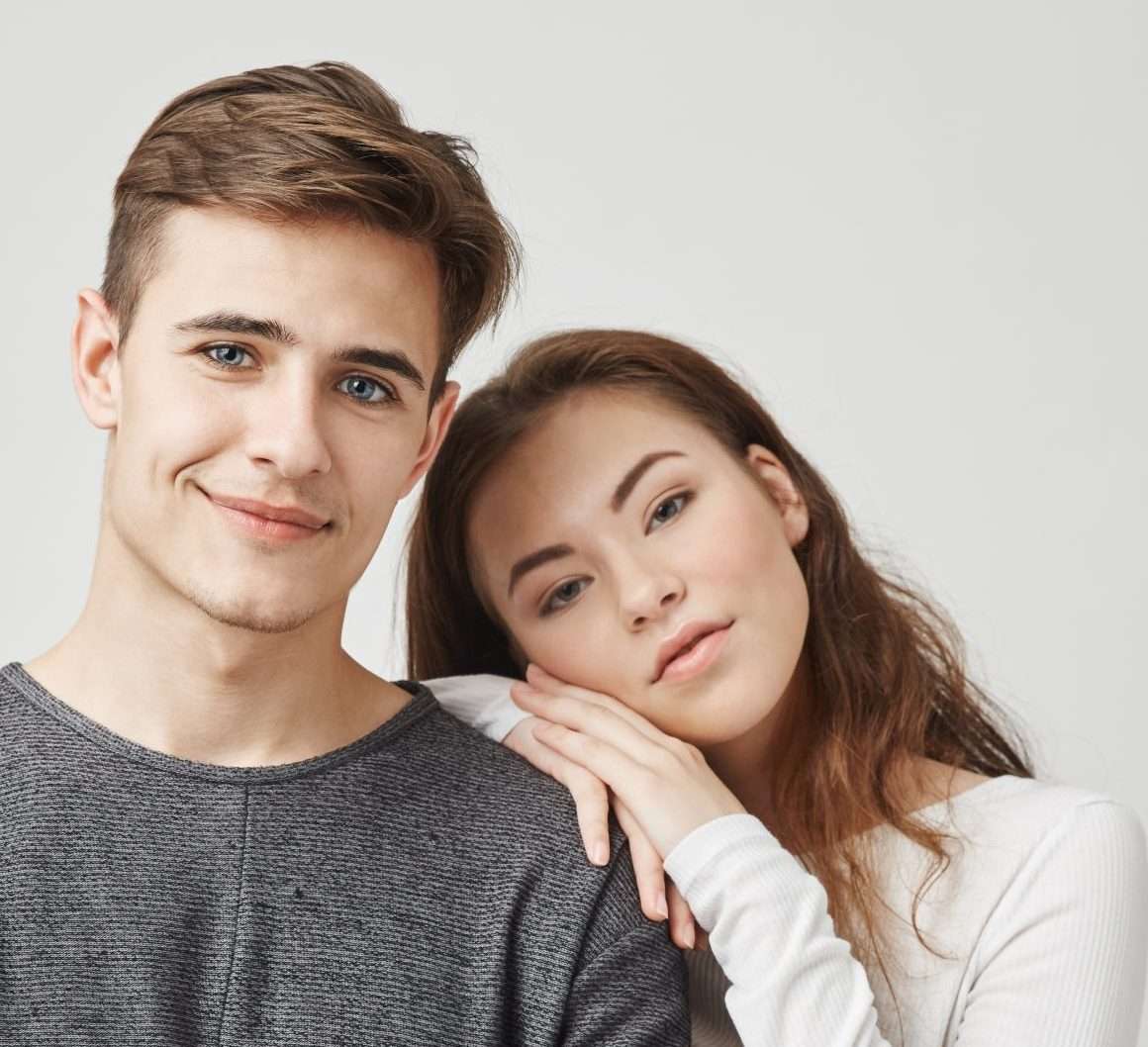 Indoor photo of a couple who recently got moved in together. They made a serious step forward so girlfriend and boyfriend hope that romance between them will only become bigger and love stronger