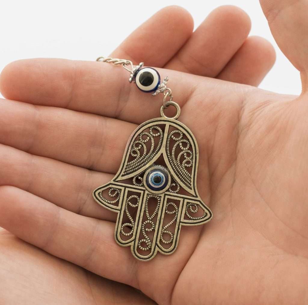 front-view-hands-holding-hamsa-pendant